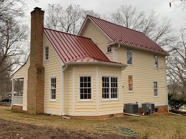 finished red standing seam metal roof on historic home