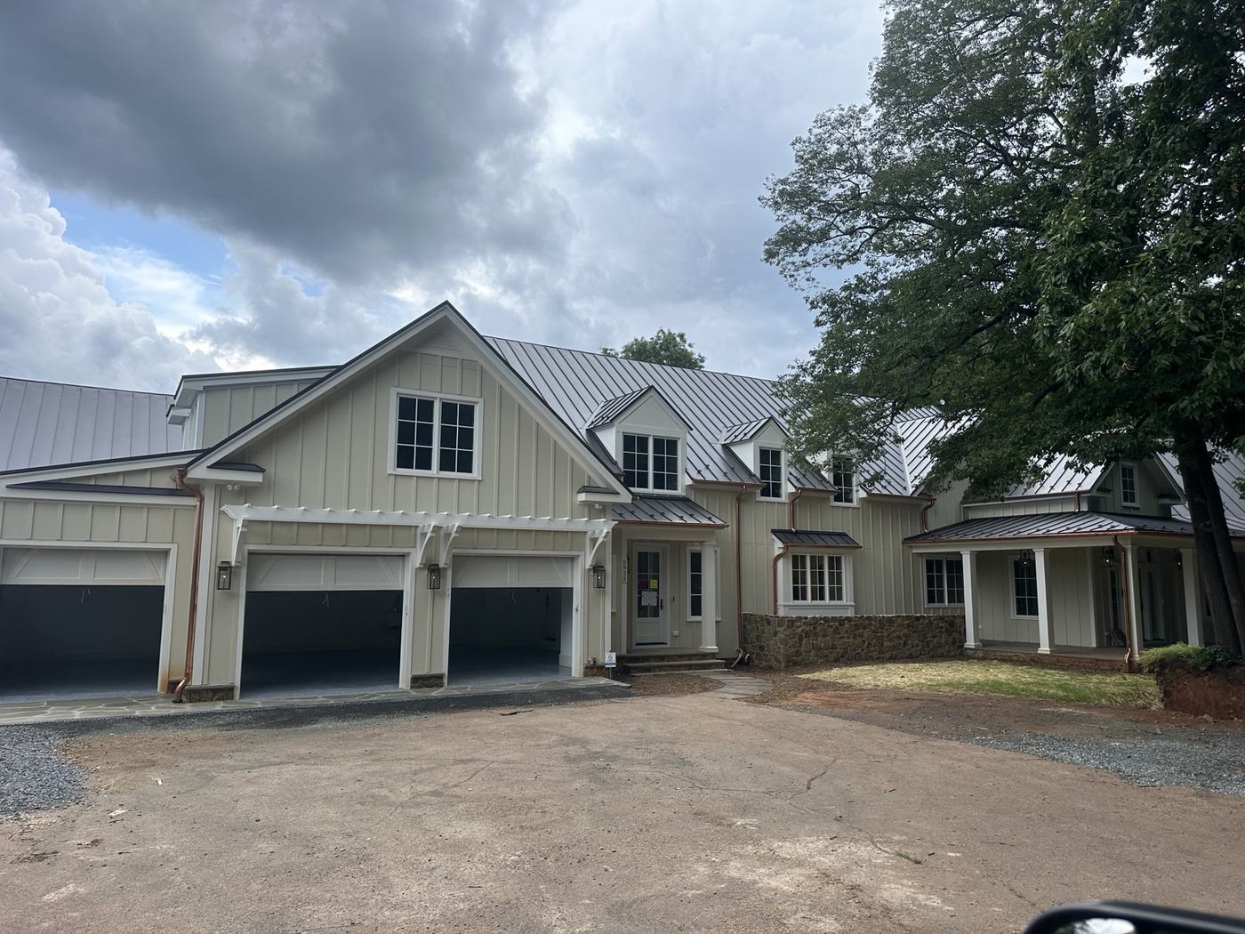 charcoal standing seam metal roof on modern custom home
