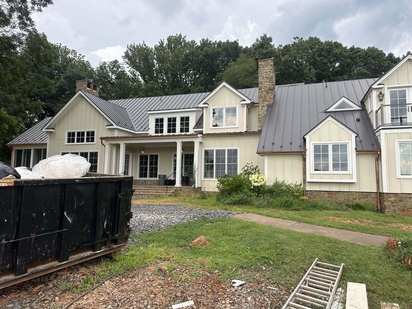 green standing seam roofing panels overlooking lake and boathouse