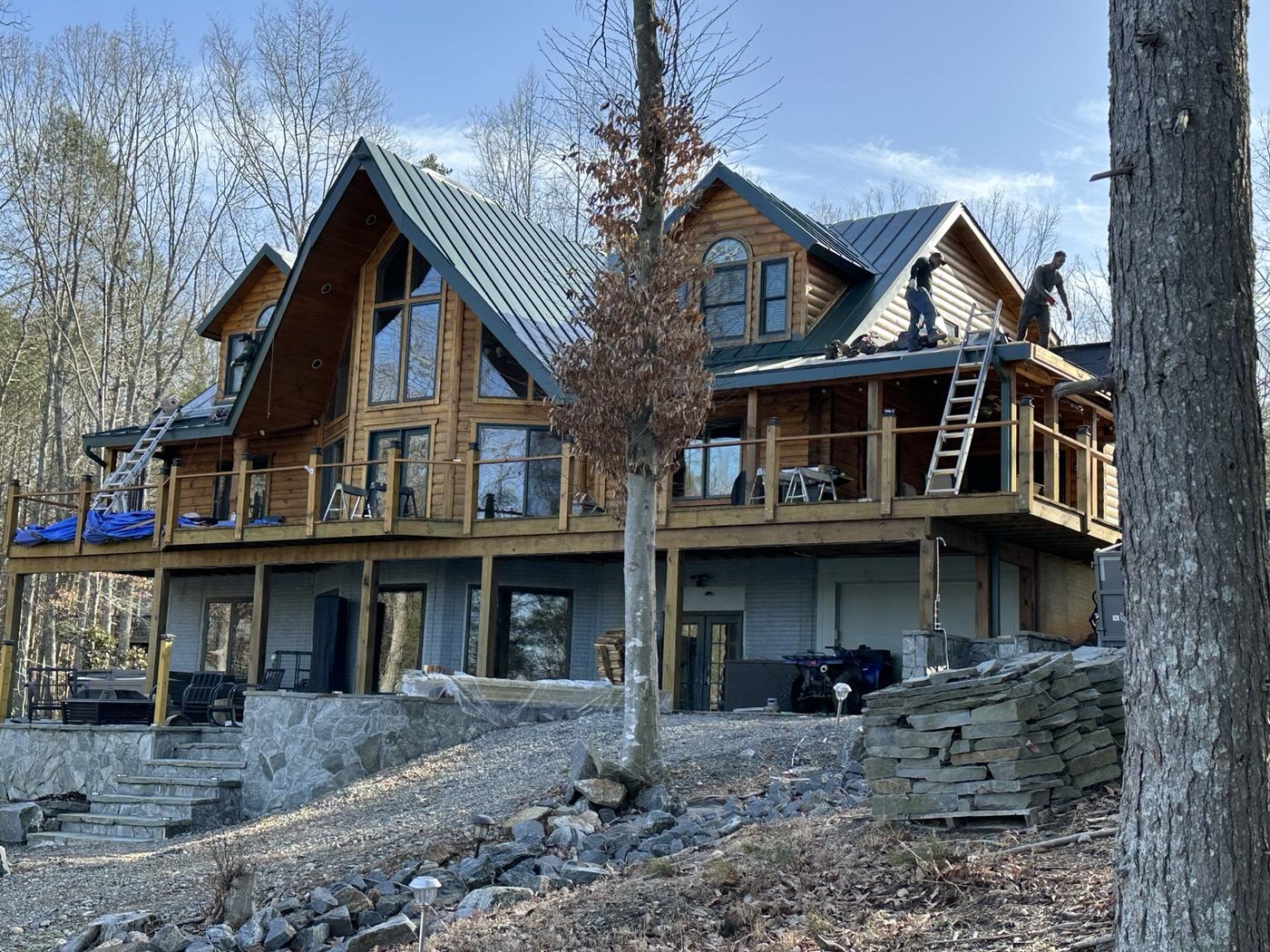 green standing seam metal roof installation over synthetic underlayment