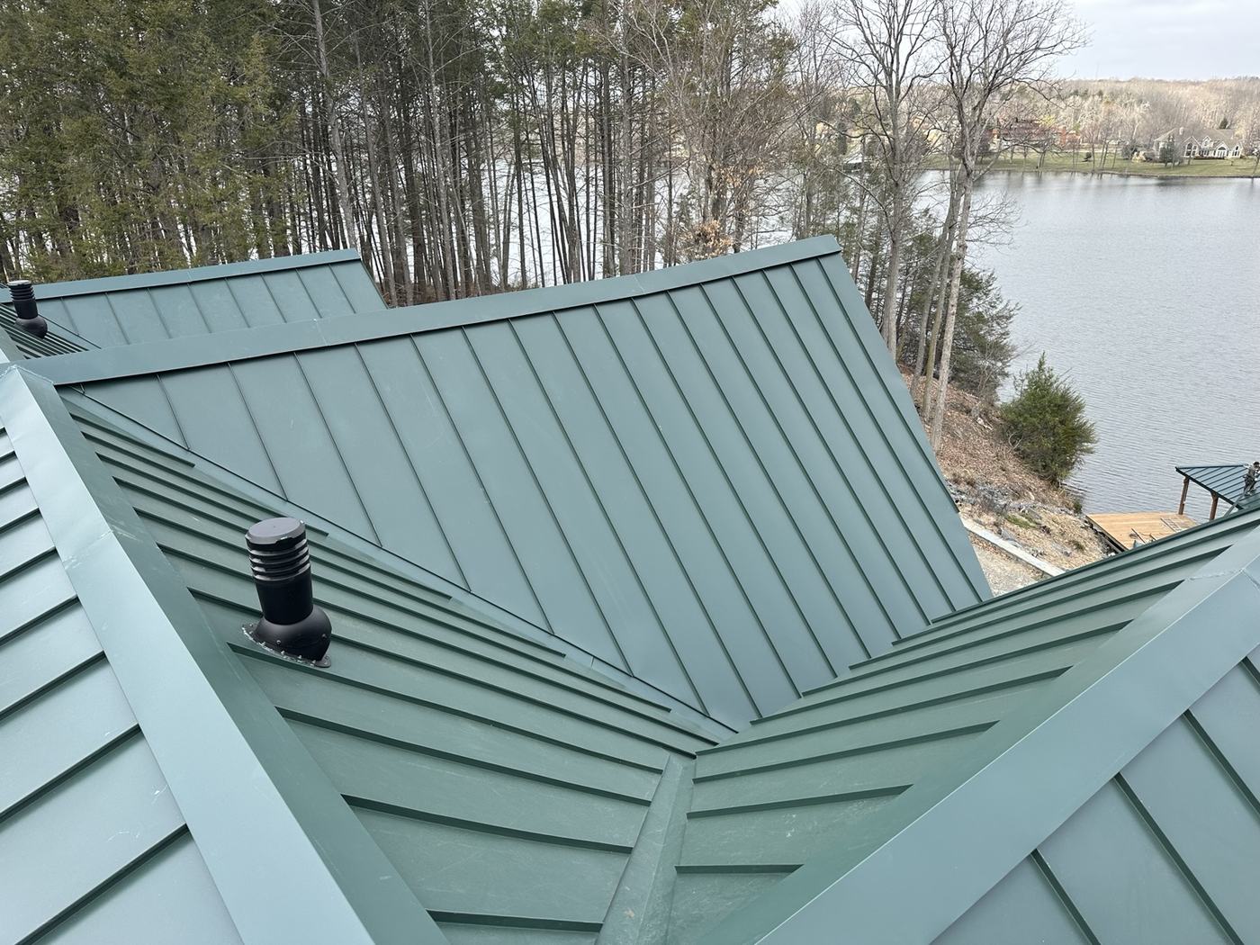 green standing seam metal roof and lakefront boathouse project