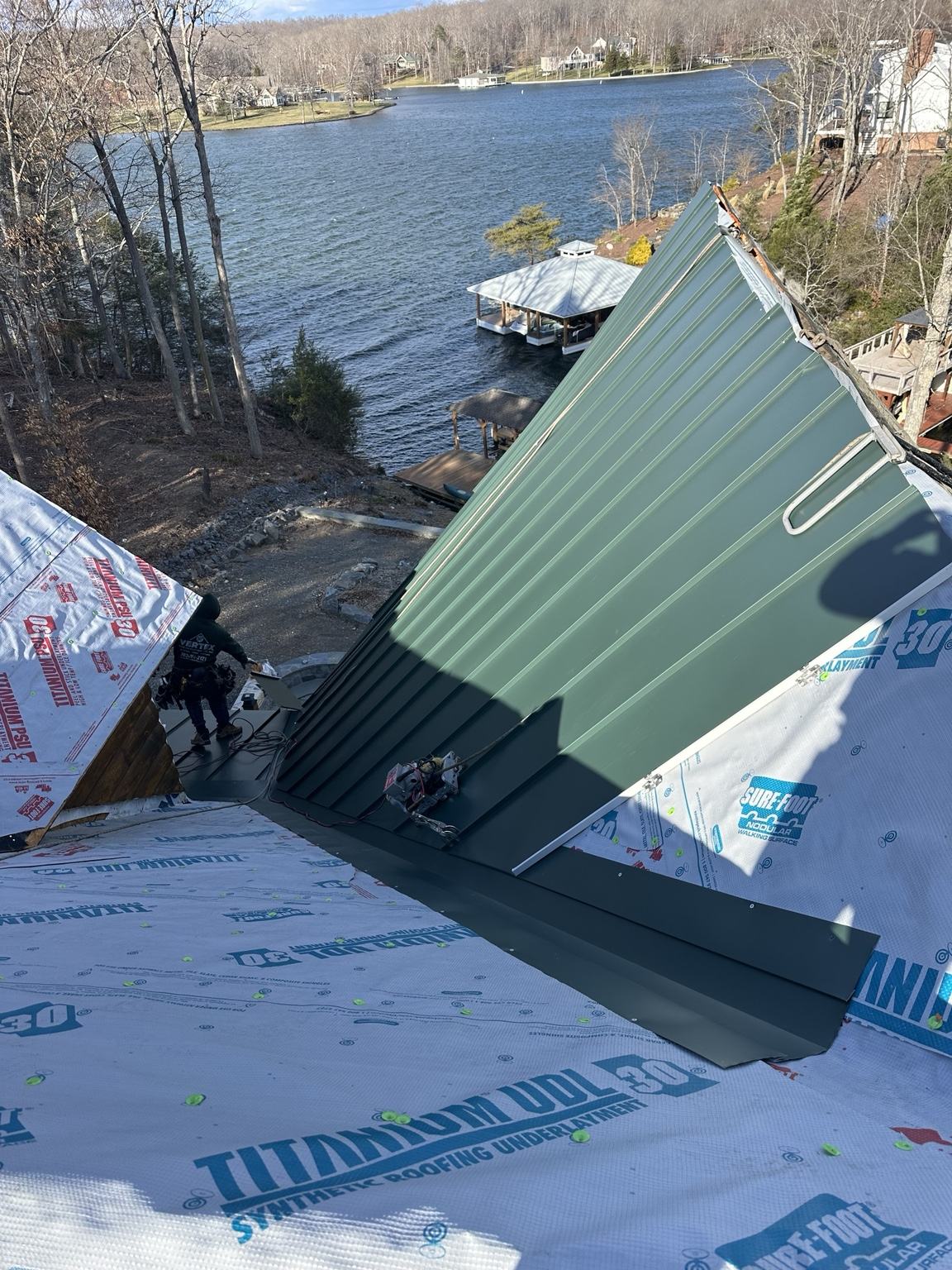 red standing seam metal roof panels on cream historic home