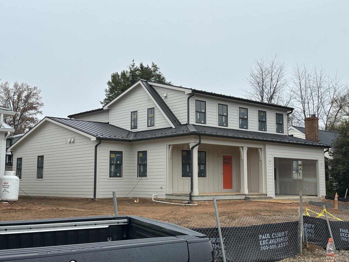 black standing seam metal roof on white church building