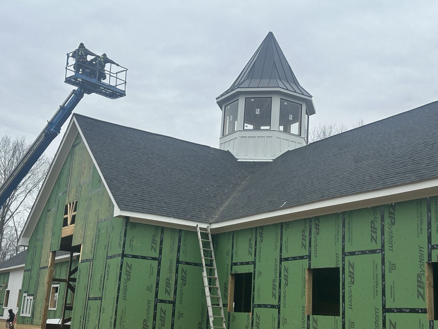 silver standing seam metal roofing panels and snow guards close up