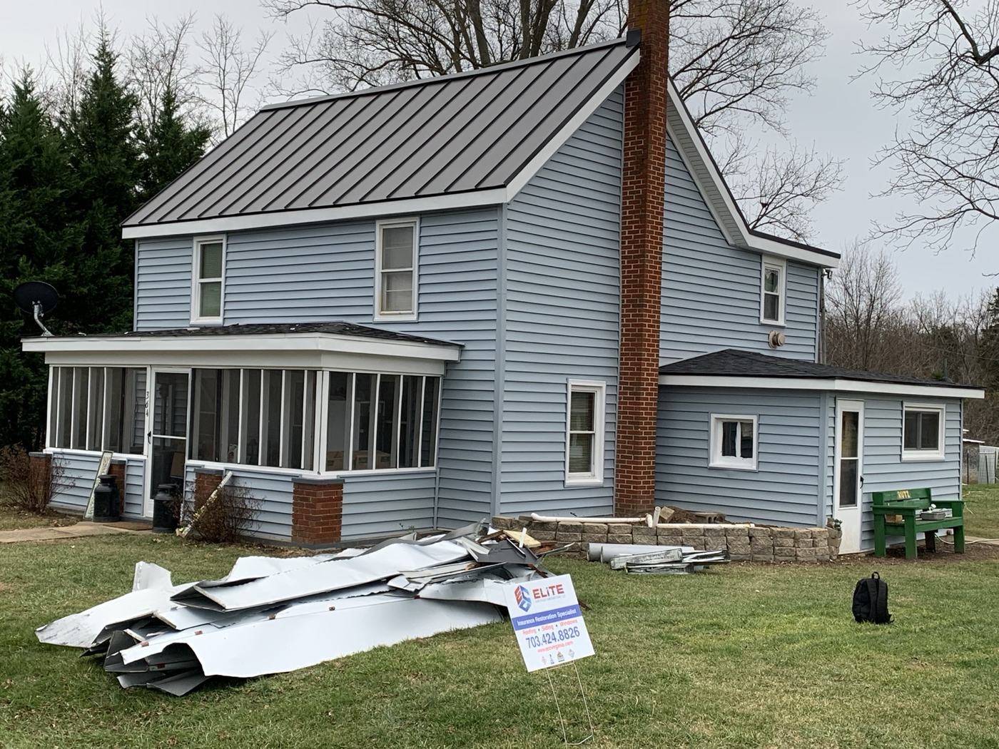 silver standing seam metal roof on custom white home