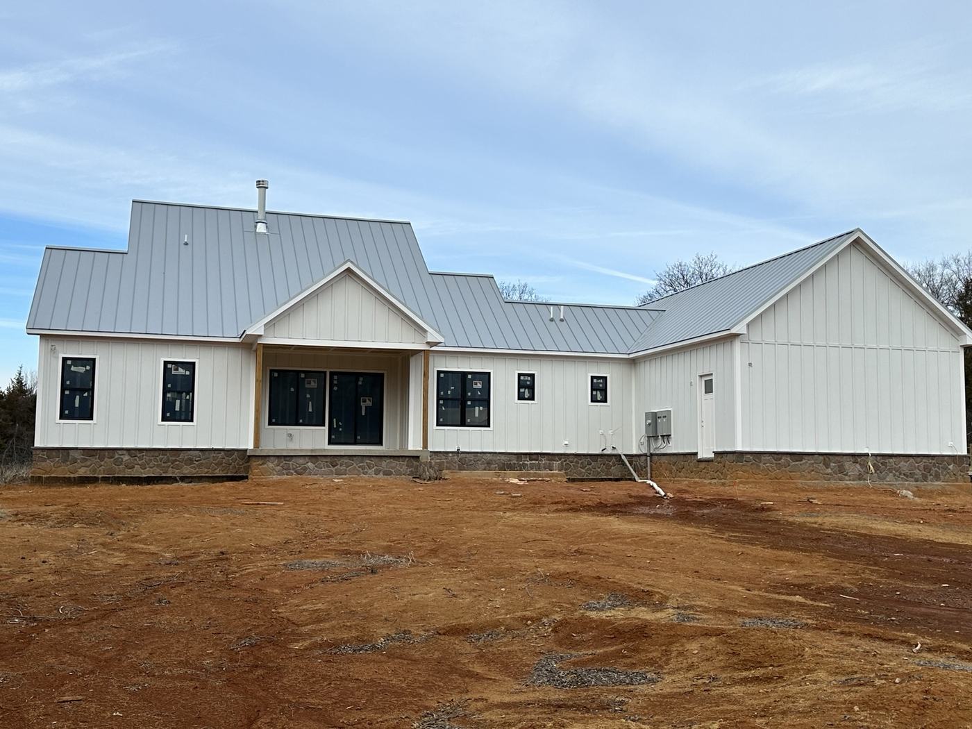 standing seam metal roof panels with light gray finish and roof valley